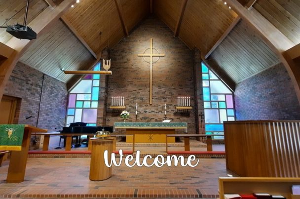 The sanctuary at St. Mark's featuring a central altar with coloured glass windows on either side. The word "Welcome" is on the picture.